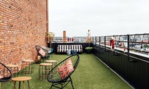 Condo rooftop terrace and outdoor seating area with surrounding urban buildings for a mortgage closing survey
