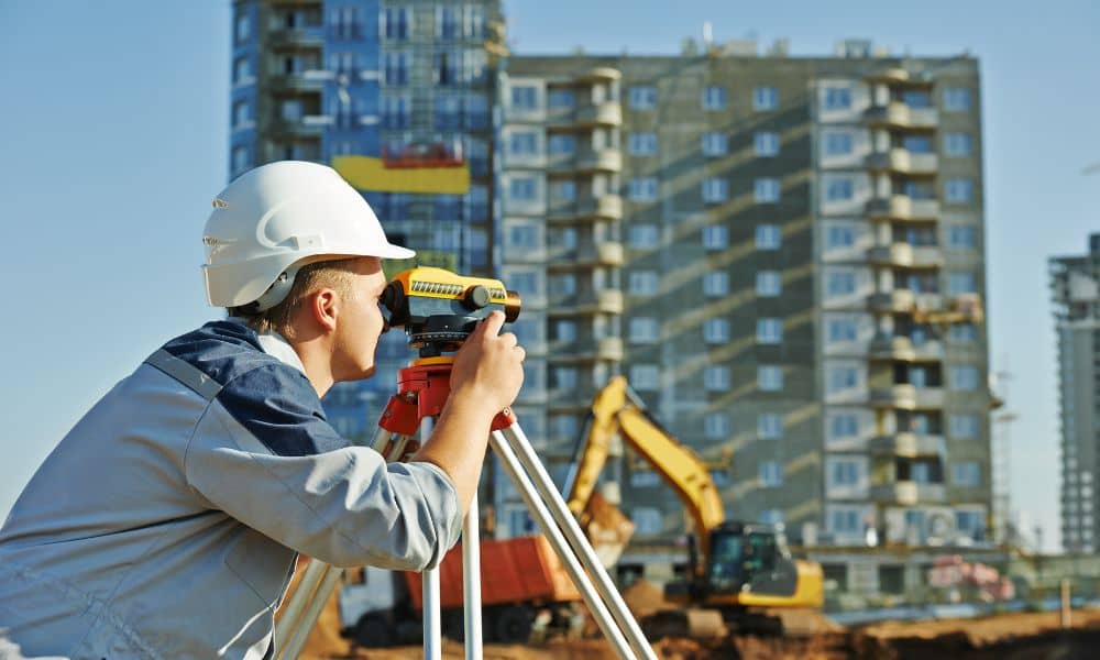 Surveyor conducting elevation surveys at a commercial building site in Chicago to evaluate flood risk
