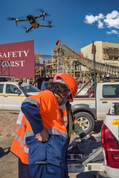 Drone surveying urban infrastructure with engineer operating equipment for safer and faster city inspections

