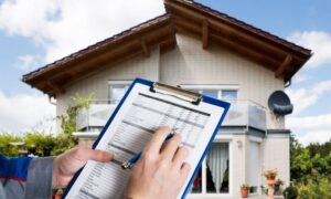 Home inspector reviewing a loan closing survey in front of a house