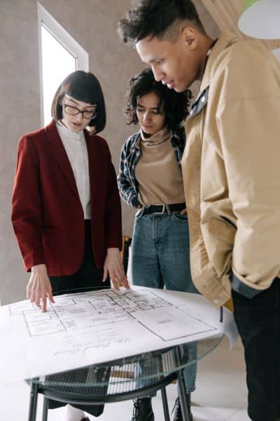 Team reviewing ALTA Land Title Survey plans together during a commercial property evaluation