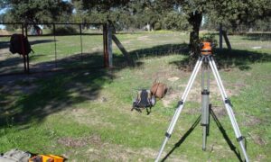 Surveying equipment set up for flood elevation surveys on open land