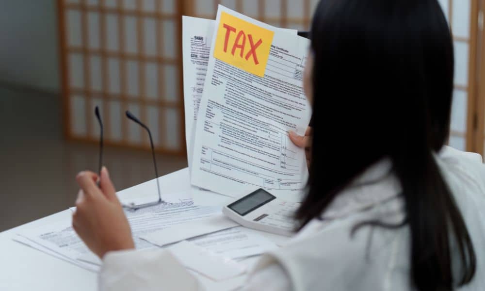 Homeowner reviewing property tax documents - ALTA SURVEY Chicago Homeowner reviewing tax documents while considering the need for property surveys after a reassessment