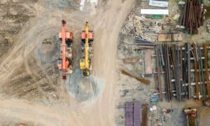 Aerial surveying view showing heavy equipment and materials arranged across an active construction site