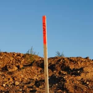Survey stake placed to mark property limits during a boundary line survey before construction