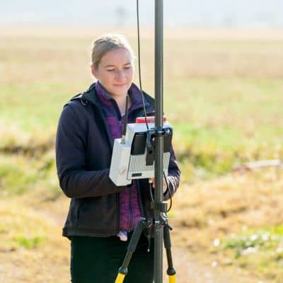 Field surveyor measuring a ground control point to improve drone surveying accuracy